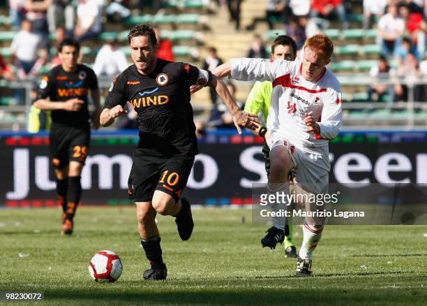 Francesco Totti of AS Roma is challenged by Alessandro Gazzi of AS Bari during the Serie A match between AS Bari and AS Roma at Stadio San Nicola on...