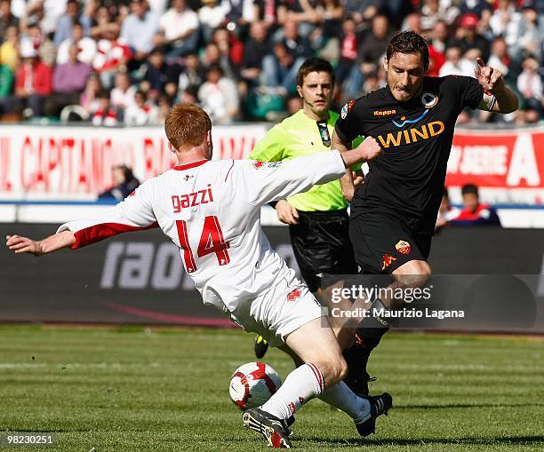 Alessandro Gazzi of AS Bari battles for the ball with Francesco Totti of AS Roma during the Serie A match between AS Bari and AS Roma at Stadio San...