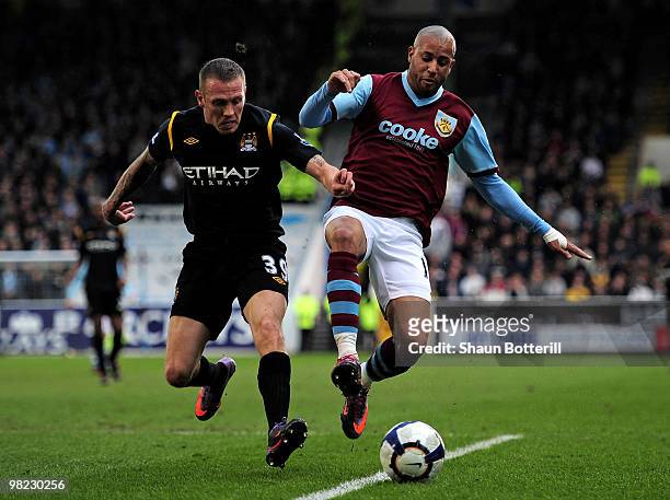 Craig Bellamy of Manchester City competes for the ball with Tyrone Mears of Burnley during the Barclays Premier League match between Burnley and...