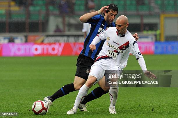 Inter Milan's Argentinian forward Alberto Milito Diego challenges Bologna's midfielder Roberto Guana during their Serie A football match at San Siro...