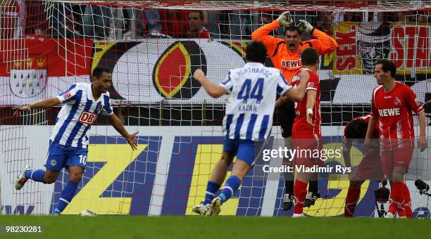 Berlin's Raffael celebrates after scoring his team's second goal as goalkeeper Faryd Mondragon of Koeln reacts during the Bundesliga match between 1....