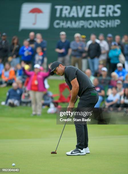 Jason Day of Australia hits a putt on the 17th hole during the third round of the Travelers Championship at TPC River Highlands on June 23, 2018 in...