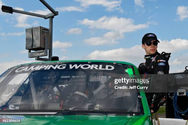 Ben Rhodes, driver of the Alpha Energy Solutions Ford, looks on during qualifying for the NASCAR Camping World Truck Series Villa Lighting delivers...