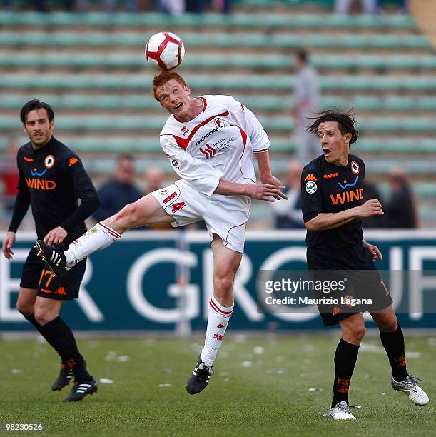 Alessandro Gazzi of AS Bari battles for the ball with Rodrigo Taddei of AS Roma during the Serie A match between AS Bari and AS Roma at Stadio San...
