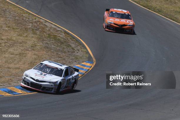 Hailie Deegan, driver of the Mobil 1/NAPA Power Premium Plus Toyota, leads Daniel Suarez, driver of the Seth Smith Arris, during the NASCAR K&N Pro...