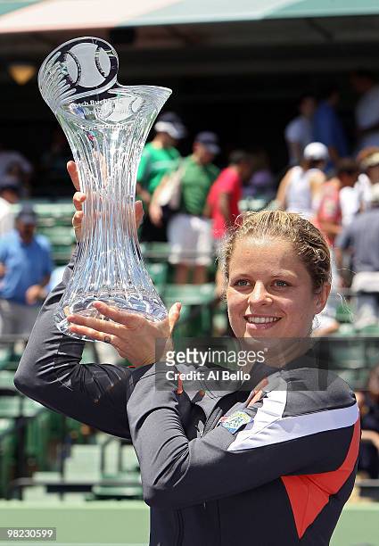 Kim Clijsters of Belgium holds the trophy after defeating Venus Williams of the United States in straight sets to win the women's final of the 2010...