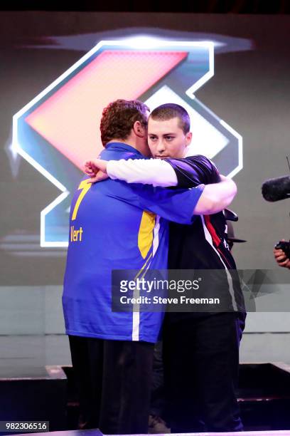 Mama Im Dat Man of Blazer5 Gaming hugs Vert of Warriors Gaming Squad after the match between the two teams on June 23, 2018 at the NBA 2K League...