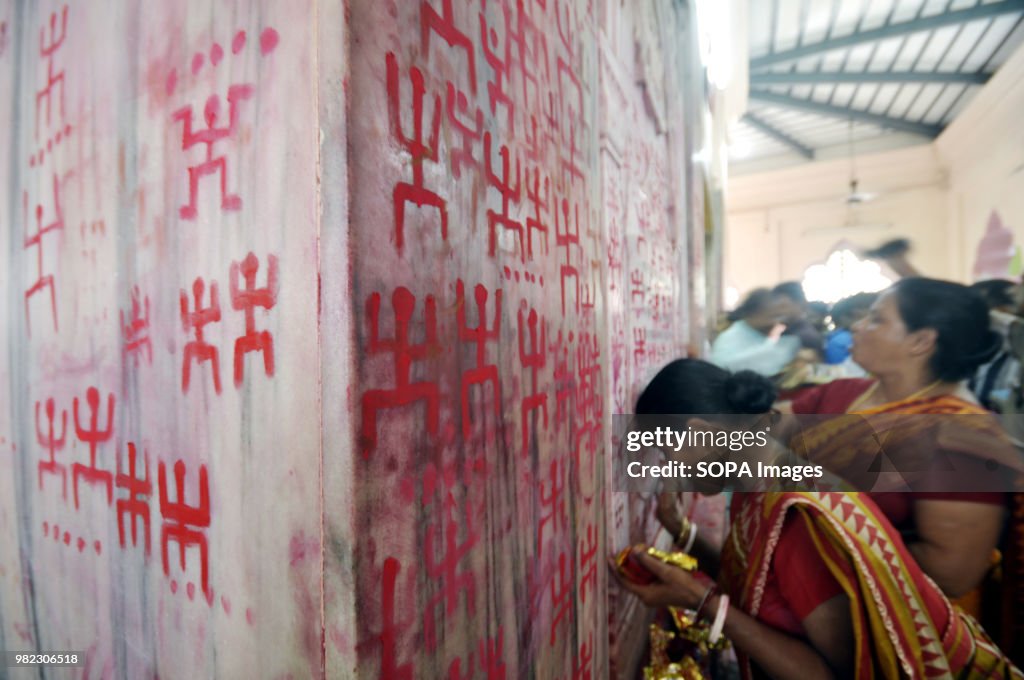 Indian women seen drawing the holy sign of Swastika during...
