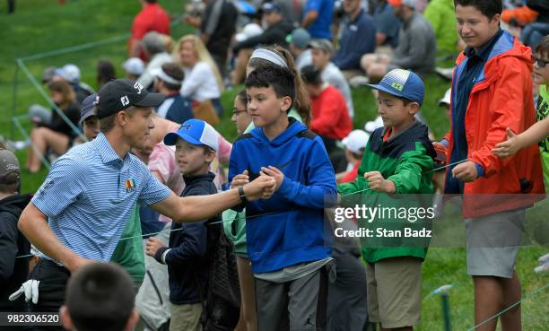 Peter Malnati fist pumps fans on the 18th hole during the third round of the Travelers Championship at TPC River Highlands on June 23, 2018 in...