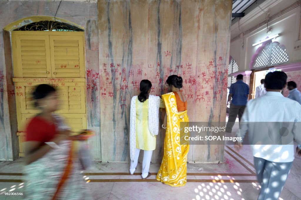 Indian women seen drawing the holy sign of Swastika during...