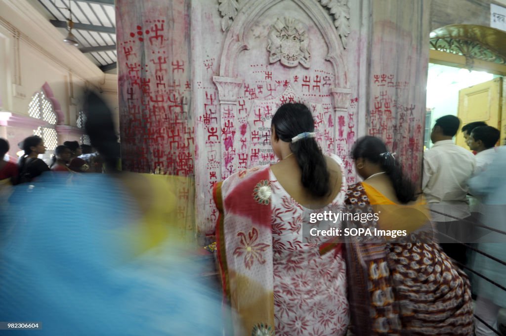 Indian women seen drawing the holy sign of Swastika during...