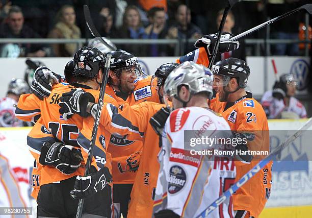 Players of Wolfsburg celebrate their third period goal against DEG Metro Stars during the third DEL quarter final play-off game between Grizzly Adams...