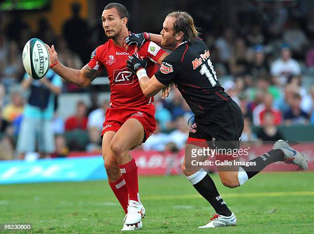 Quade Cooper of the Reds is tackled by Andy Goode of the Sharks during the Super 14 match between Sharks and Reds at Absa Stadium on April 03, 2010...