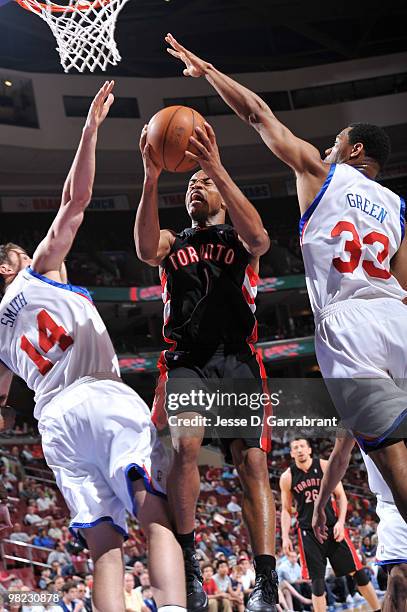 Jarrett Jack of the Toronto Raptors shoots against Jason Smith and Willie Green of the Philadelphia 76ers during the game on April 3, 2010 at the...