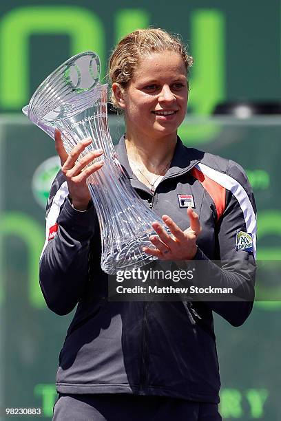 Kim Clijsters of Belgium holds the trophy after defeating Venus Williams of the United States in straight sets to win the women's final of the 2010...