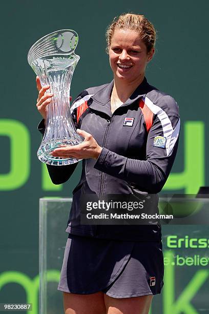 Kim Clijsters of Belgium holds the trophy after defeating Venus Williams of the United States in straight sets to win the women's final of the 2010...