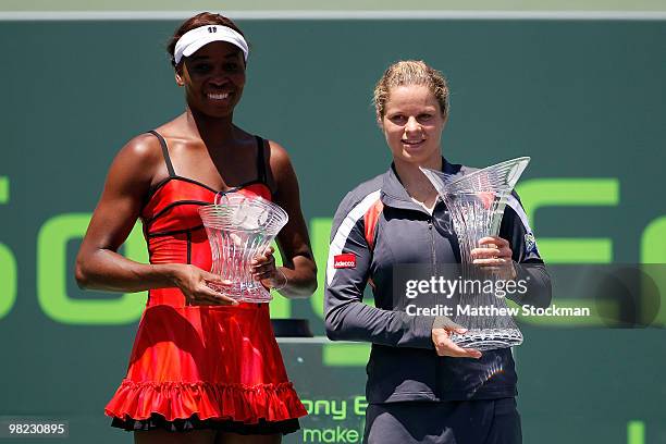 Kim Clijsters of Belgium and Venus Williams of the United States hold their trophies after the women's final of the 2010 Sony Ericsson Open at...