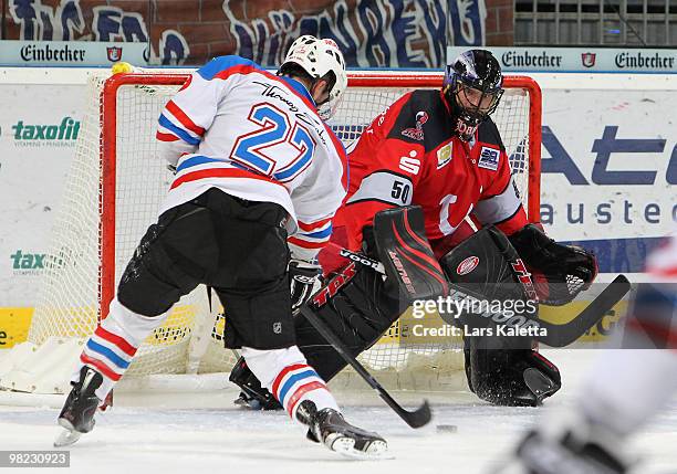 Petr Fical of Nuernberg scores a goal to lead 2:5 against Travis Scott goalkeeper of Hannover during the third DEL quarter final play-off game...
