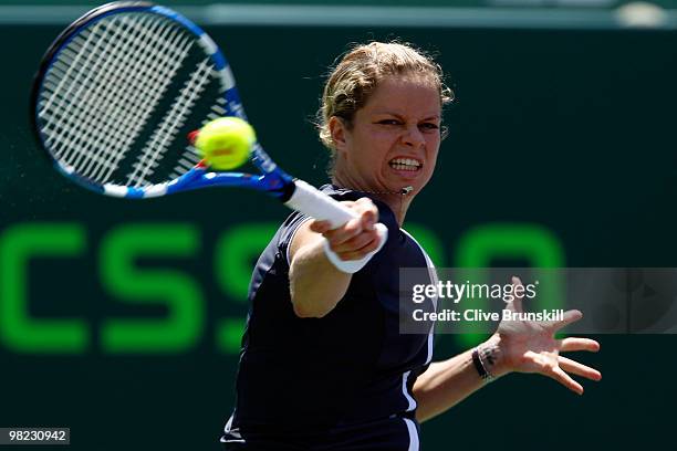 Kim Clijsters of Belgium returns a shot against Venus Williams of the United States during the women's final of the 2010 Sony Ericsson Open at...