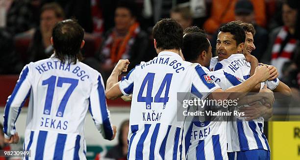 Cicero of Berlin is celebrated by his team mates after scoring his team's third goal during the Bundesliga match between 1. FC Koeln and Hertha BSC...