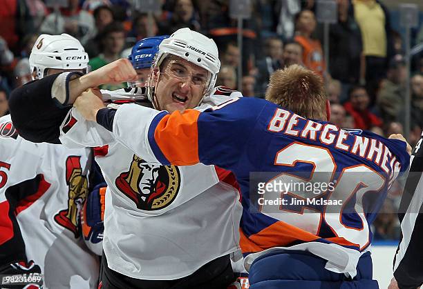 Nick Foligno of the Ottawa Senators throws a punch against Sean Bergenheim of the New York Islanders on April 3, 2010 at Nassau Coliseum in...