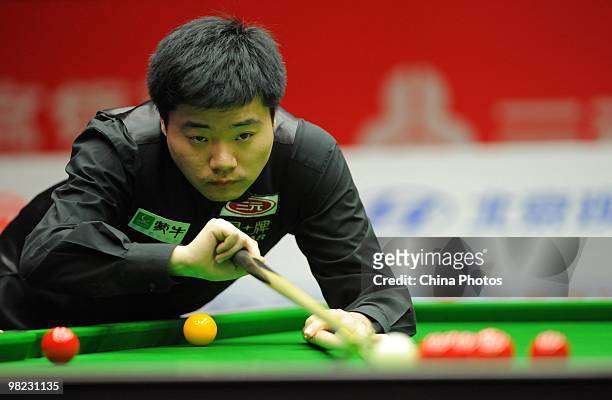 Ding Junhui of China lines up a shot during his semifinal match against Mark Allen of Northern Ireland during the 6th day of the 2010 World Snooker...