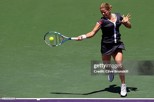 Kim Clijsters of Belgium returns a shot against Venus Williams of the United States during the women's final of the 2010 Sony Ericsson Open at...