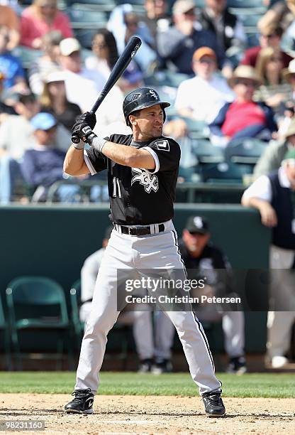 Omar Vizquel of the Chicago White Sox bats against the Oakland Athletics during the MLB spring training game at Phoenix Municipal Stadium on March...