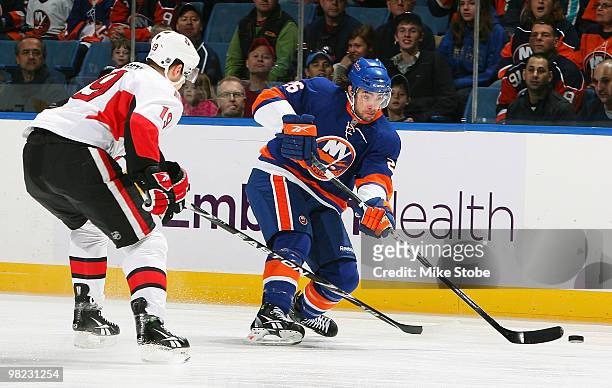 Jason Spezza of the Ottawa Senators defends against Matt Moulson of the New York Islanders on April 3, 2010 at Nassau Coliseum in Uniondale, New York.