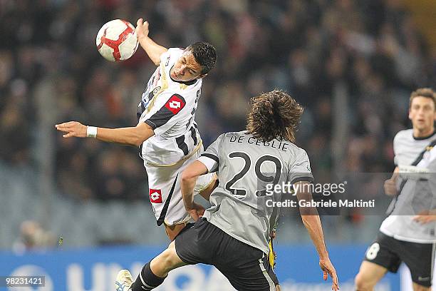 Antonio Di Natale of Udinese Calcio competes for the ball with Paolo De Ceglie of Juventus FC during the Serie A match between Udinese Calcio and...