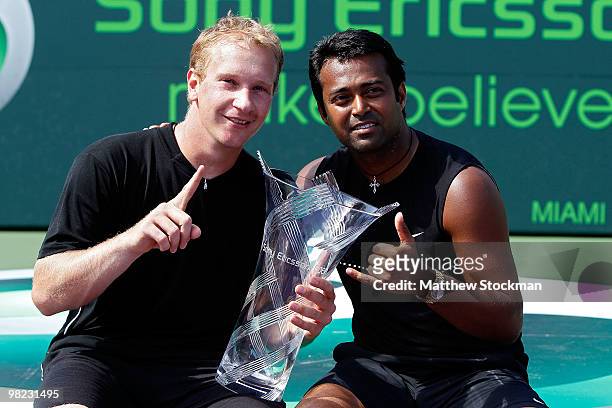 Lukas Dlouhy of the Czech Republic and Leander Paes of India hold the trophy after defeating Mahesh Bhupathi of India and Max Mirnyi of Belarus to...