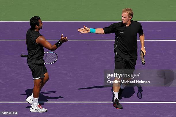 Lukas Dlouhy of the Czech Republic and Leander Paes of India celebrate a point against Mahesh Bhupathi of India and Max Mirnyi of Belarus to win the...