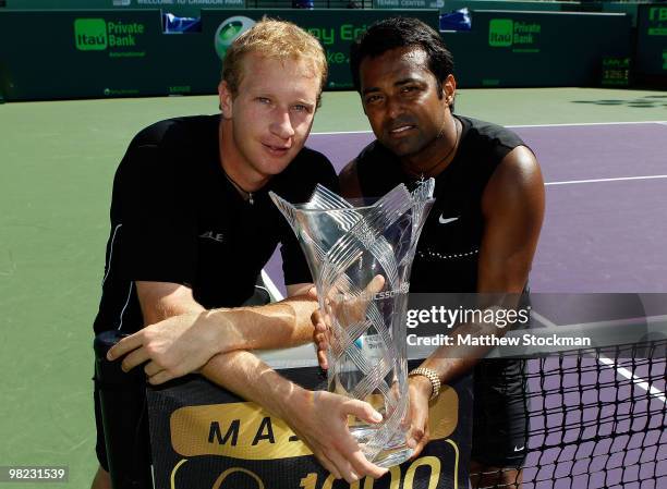 Lukas Dlouhy of the Czech Republic and Leander Paes of India hold the trophy after defeating Mahesh Bhupathi of India and Max Mirnyi of Belarus to...