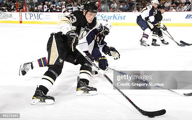 Alexei Ponikarovsky of the Pittsburgh Penguins skates past the defense of Marty Reasoner of the Atlanta Thrashers on April 3, 2010 at Mellon Arena in...