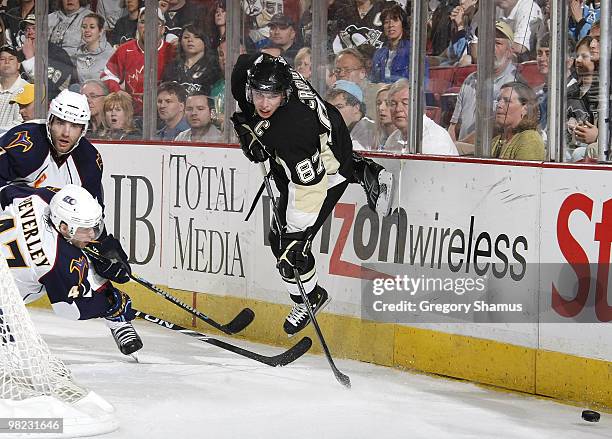 Sidney Crosby of the Pittsburgh Penguins moves the puck in front of Rich Peverly of the Atlanta Thrashers on April 3, 2010 at Mellon Arena in...