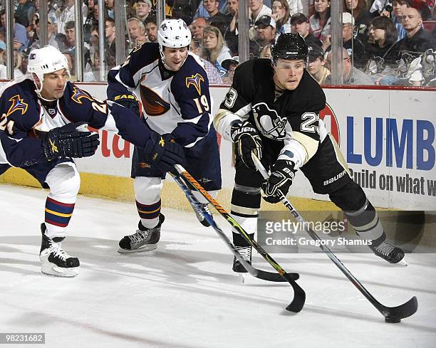 Alexei Ponikarovsky of the Pittsburgh Penguins controls the puck in front of Chris Chelios and Marty Reasoner of the Atlanta Thrashers on April 3,...