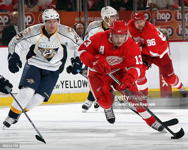 Pavel Datsyuk of the Detroit Red Wings tries to keep control of the puck away from Patric Hornqvist of the Nashville Predators during an NHL game at...
