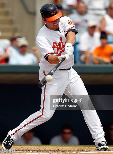 Infielder Garrett Atkins of the Baltimore Orioles fouls off a pitch against the New York Mets during a Grapefruit League Spring Training Game at Ed...