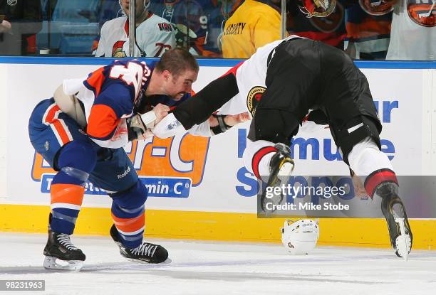 Matt Carkner of the Ottawa Senators gets airborne in a fight with Trevor Gillies of the New York Islanders on April 3, 2010 at Nassau Coliseum in...