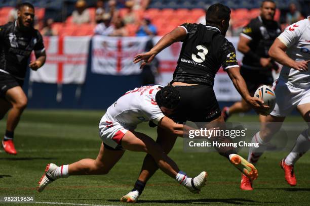 England Jonny Lomax, left, tackles New Zealand San Marsters during Denver Test game of Rugby League International at Broncos Stadium at Mile High...
