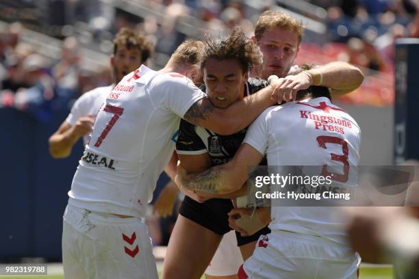 England defenders stop New Zealand Raymond Faitala-Mariner with ball during Denver Test game of Rugby League International at Broncos Stadium at Mile...