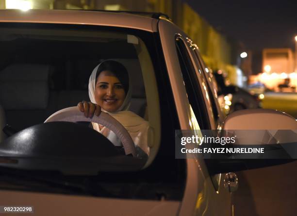 Saudi Samar Almogren prepares to drive her car through Riyadh city's streets for the first time just after midnight, June 24 when the law allowing...