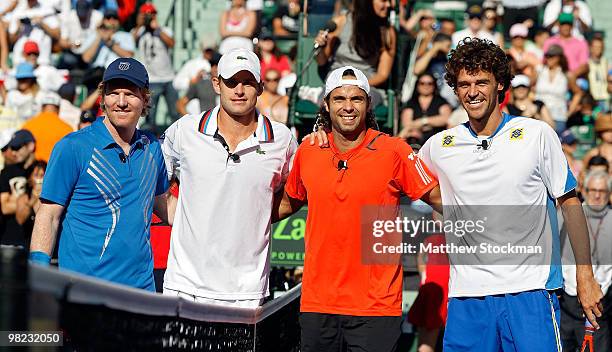 Andy Roddick of the United States, Jim Courier of the United States, Fernando Gonzalez of CHile and Gustavo Kuerten of Brazil pose at the net during...