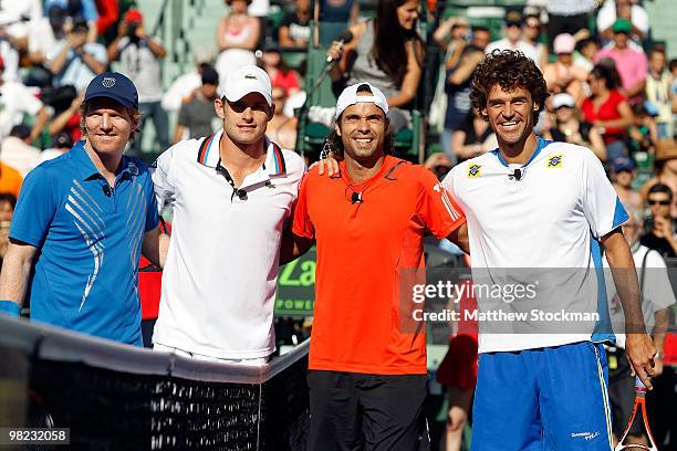 Andy Roddick of the United States, Jim Courier of the United States, Fernando Gonzalez of CHile and Gustavo Kuerten of Brazil pose at the net during...