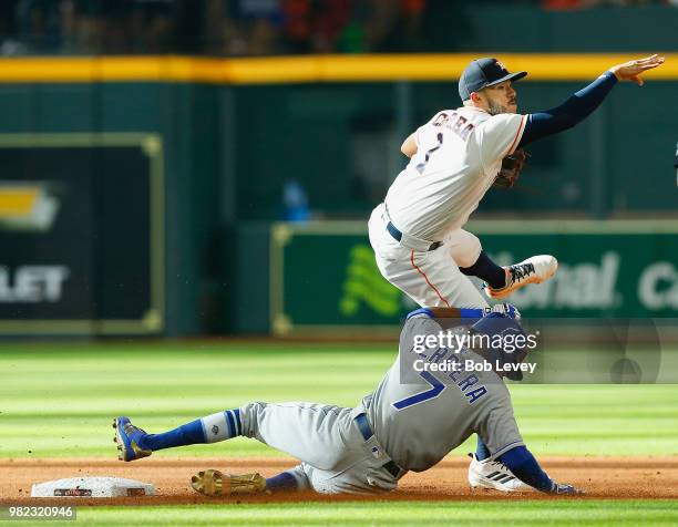 Carlos Correa of the Houston Astros throws over a sliding Rosell Herrera of the Kansas City Royals in the first inning at Minute Maid Park on June...