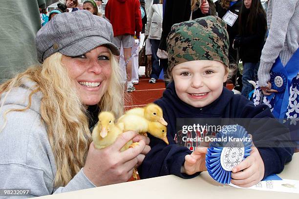 Mom Kara holds the 3 chicks, Mac, Manco and Mia whille daughter 3 year old Victoria holds 1st Place Ribbon while attending the Woofin' Paws Pet...