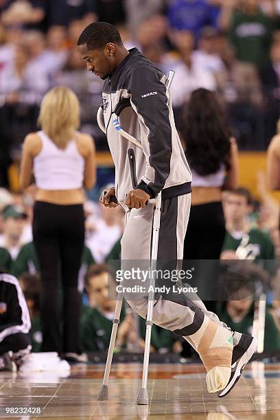 Injured guard Kalin Lucas of the Michigan State Spartans arrives at the court on crutches against the Butler Bulldogs during the National Semifinal...