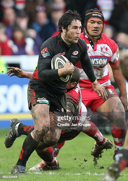 Brad Barritt of Saracens shrugs off Tim Molenaar of Gloucester during the Guinness Premiership match between Gloucester and Saracens at Kingsholm...