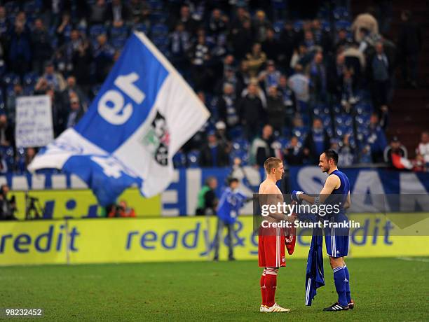 Bastian Schweinstieger of Bayern exchanges his shirt with Heiko Westermann of Schalke at the end of the Bundesliga match between FC Schalke 04 and FC...