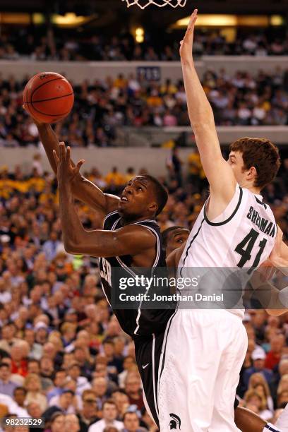 Shelvin Mack of the Butler Bulldogs drives for a shot attempt against Garrick Sherman of the Michigan State Spartans during the National Semifinal...